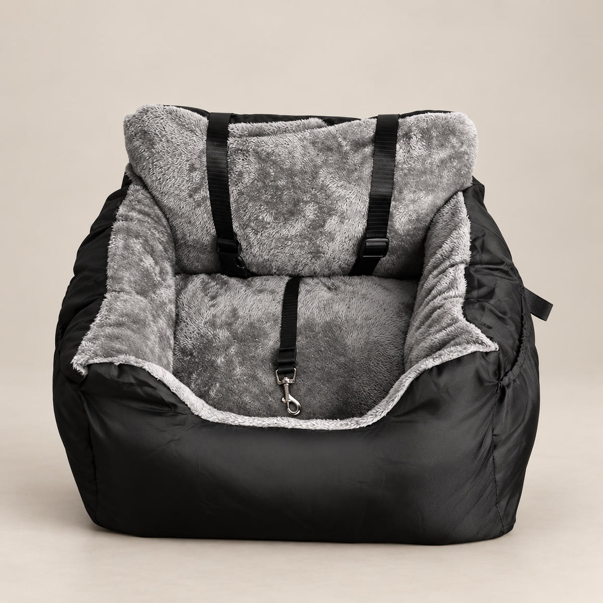 Black plush dog car booster seat with grey fleece lining - studio photograph on a warm neutral backdrop