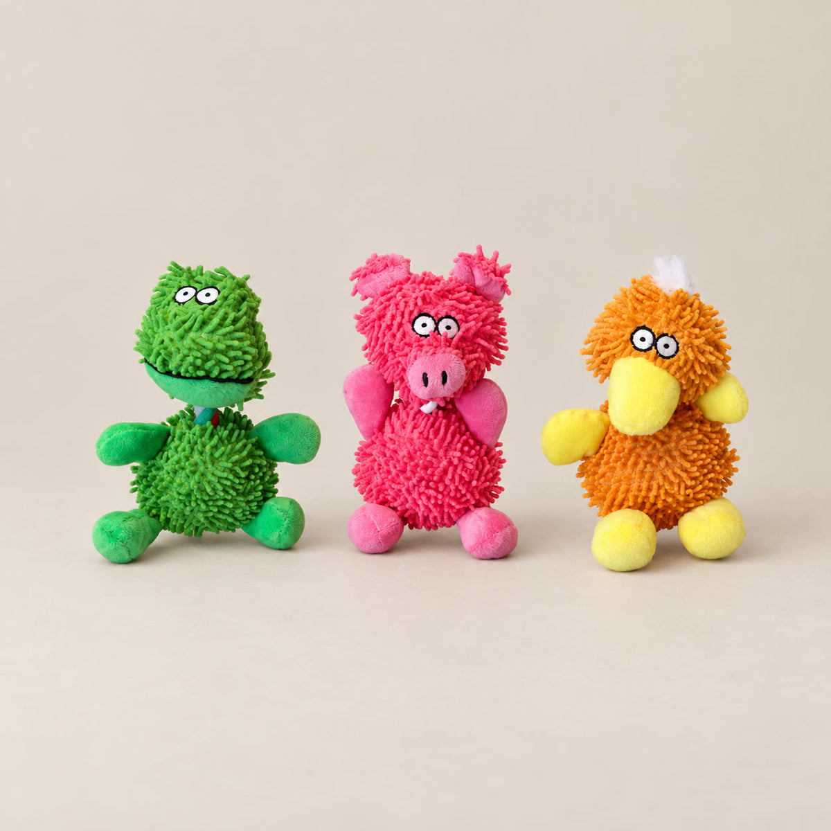 Soft squeaky animal dog toys, about 20 cm - studio photograph on a warm neutral backdrop