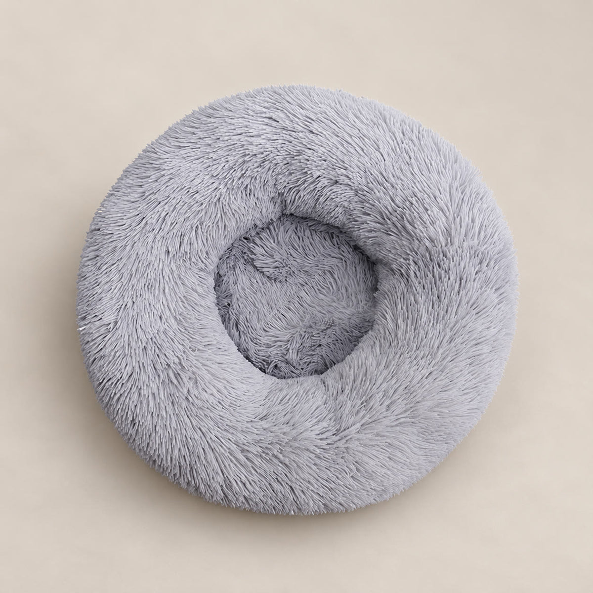 Light grey 80 cm round donut pet bed with plush faux fur - studio photograph on a warm neutral backdrop